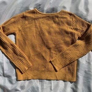 Gold knitted sweater with criss cross detailing on the back